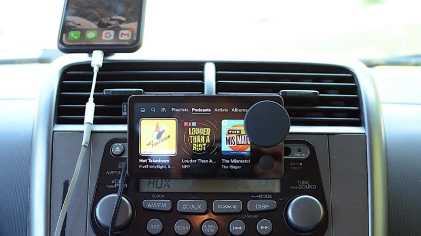 Photo of the Spotify Car Thing, a dash-mounted device with a four-inch screen and dial.