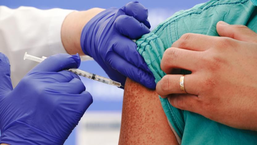 A healthcare worker receives the Covid-19 vaccination. Photographer: Bing Guan/Bloomberg