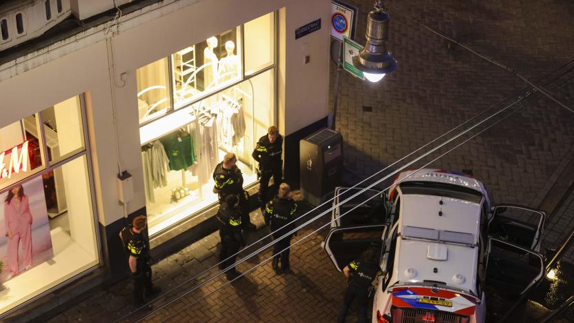 Police officers by a police vehicle near Leidseplein during an hostage situation in an Amsterdam's Apple Store on February 22, 2022. - A man with a firearm was in the vicinity of an Amsterdam shop, police in the Netherlands said February 22, 2022 adding that officers were at the scene said by local media to be an Apple store. - Netherlands OUT (Photo by Laurens Bosch / ANP / AFP) / Netherlands OUT (Photo by LAURENS BOSCH/ANP/AFP via Getty Images)