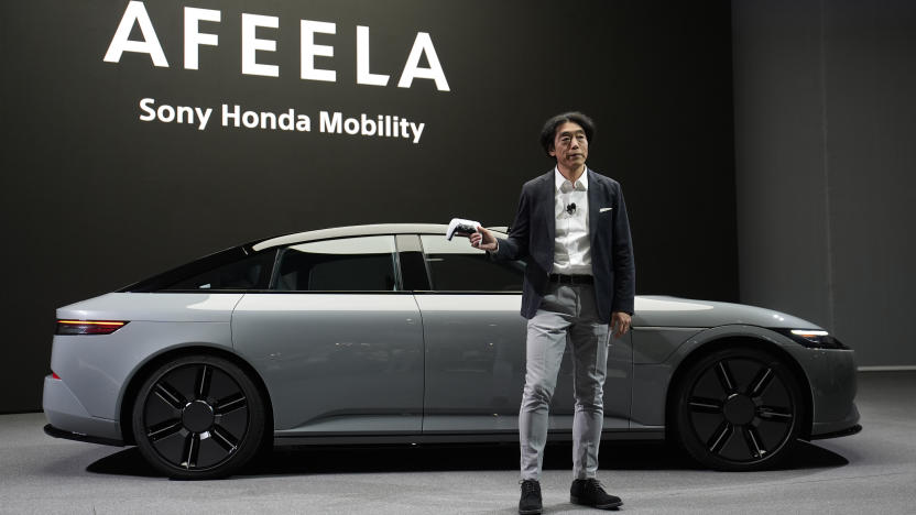 Izumi Kawanishi, president and COO of Sony Honda Mobility Inc., holds up a PlayStation controller after using it to drive an Afeela EV onto the stage during a Sony press conference ahead of the CES tech show Monday, Jan. 8, 2024, in Las Vegas. (AP Photo/John Locher)