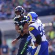 DETROIT, MI - OCTOBER 02: Seattle Seahawks QB Geno Smith (7) makes a throw  while falling to the ground but was flagged for intentional grounding  during the game between Seattle Seahawks and