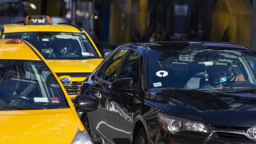 NEW YORK, NY - NOVEMBER 16: Yellow cabs and Uber car drive through Times Square on November 16, 2020 in New York City. NYC bill is looking to put Uber and yellow Cabs on single app platform where riders order from the app any for-hire vehicle, including taxis and cars of Uber or Lyft. (Photo by Eduardo MunozAlvarez/VIEWpress)