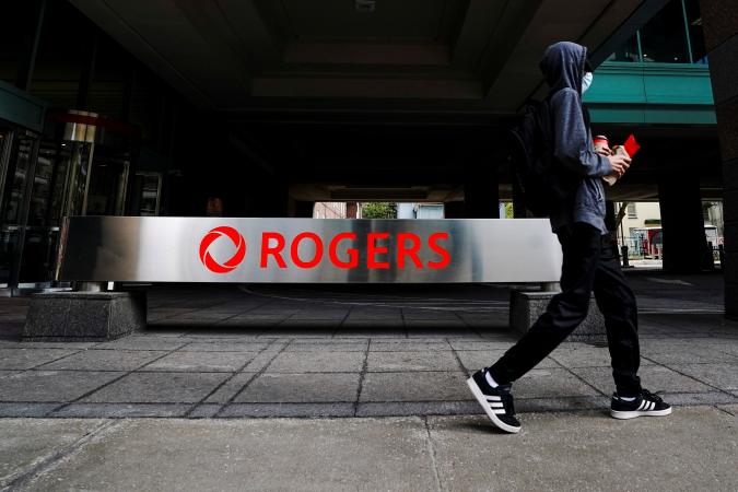 A person walks near the Rogers Building, quarters of Rogers Communications in Toronto, Ontario, Canada October 22, 2021.   REUTERS/Carlos Osorio