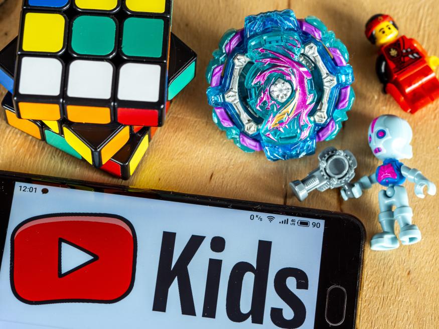 UKRAINE - 2020/11/29: In this photo illustration a YouTube Kids logo displayed on a smartphone next to kids' toys. (Photo Illustration by Valera Golovniov/SOPA Images/LightRocket via Getty Images)