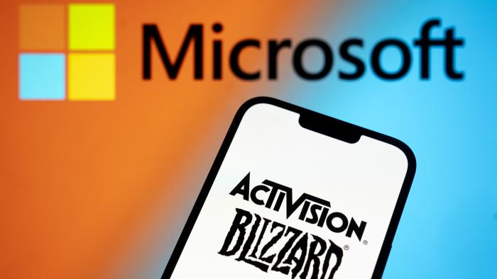 The Activision Blizzard logo is seen with a Microsoft logo in the background in this photo illustration on 13 July, 2023 in Warsaw, Poland. (Photo by Jaap Arriens/NurPhoto via Getty Images)