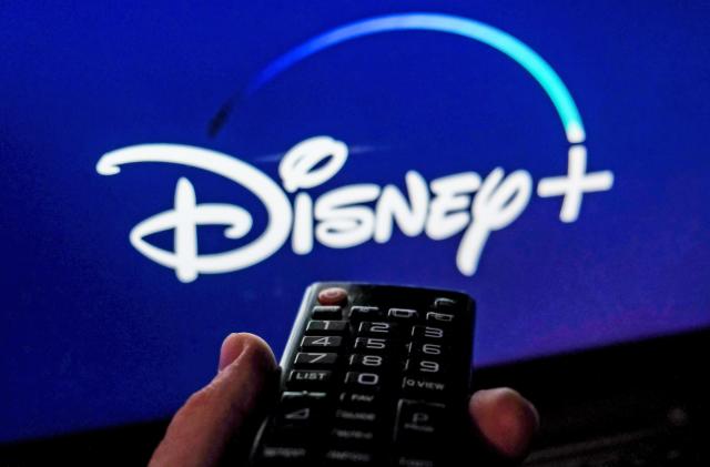 TV remote control is seen with Disney+ logo displayed on a screen in this illustration photo taken in Krakow, Poland on February 6, 2022. 