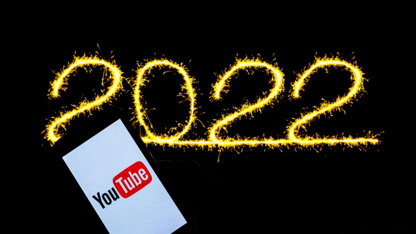 POLAND - 2021/12/21: In this photo illustration a Youtube logo seen displayed on a smartphone and illuminated 2022 New year in the background. (Photo Illustration by Filip Radwanski/SOPA Images/LightRocket via Getty Images)