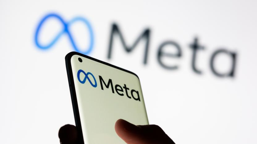 Woman holds smartphone with Meta logo in front of a displayed Facebook's new rebrand logo Meta in this illustration picture taken October 28, 2021. REUTERS/Dado Ruvic/Illustration