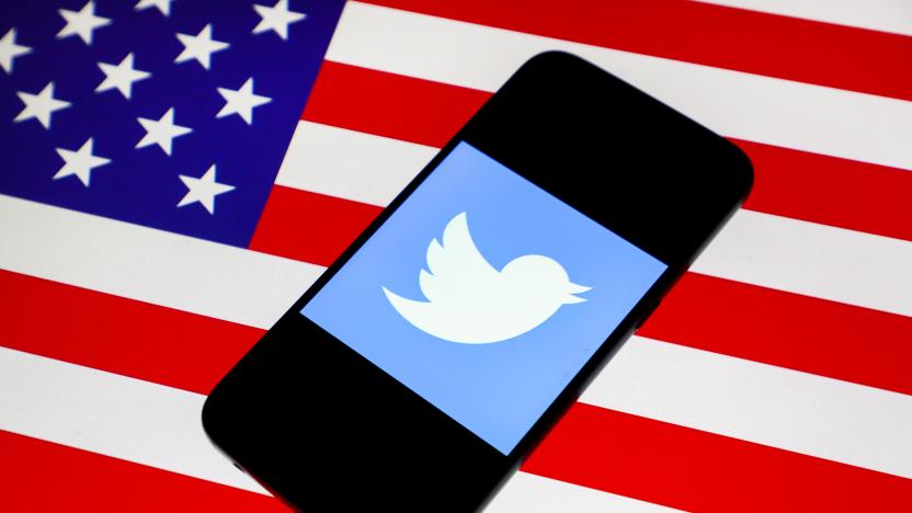 Twitter logo is displayed on a mobile phone screen photographed on U.S. national flag background arranged for illustration photo taken in Krakow, Poland on 15th January, 2020. (Photo illustration by Beata Zawrzel/NurPhoto via Getty Images)