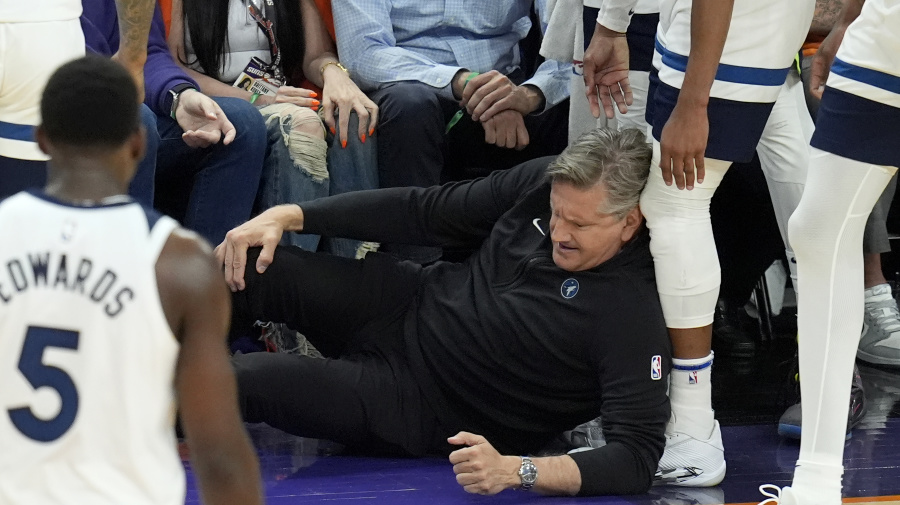 Associated Press - Minnesota Timberwolves head coach Chris Finch holds his knee after colliding with Timberwolves guard Mike Conley during the second half of Game 4 of an NBA basketball first-round playoff series against the Phoenix Suns Sunday, April 28, 2024, in Phoenix. The Timberwolves won 122-116, taking the series 4-0. (AP Photo/Ross D. Franklin)