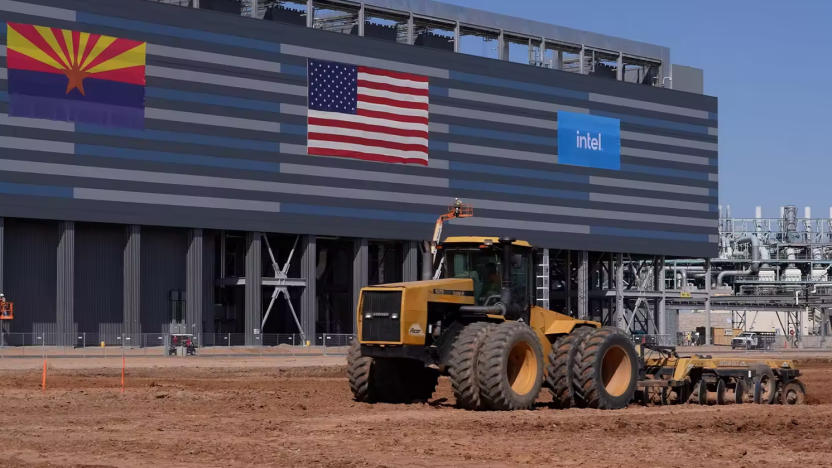 A construction truck in front of a building with the American flag and Intel's logo.