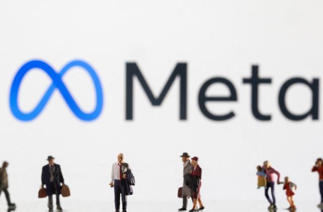 Small figurines are seen in front of displayed Meta logo in this illustration taken February 11, 2022. REUTERS/Dado Ruvic/Ilustration