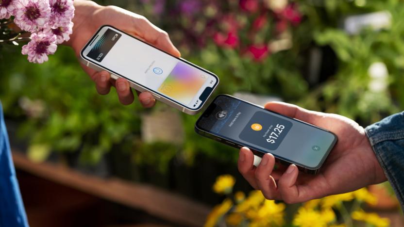 Two people (closeup of hands and phones) tapping phones together for a transaction.