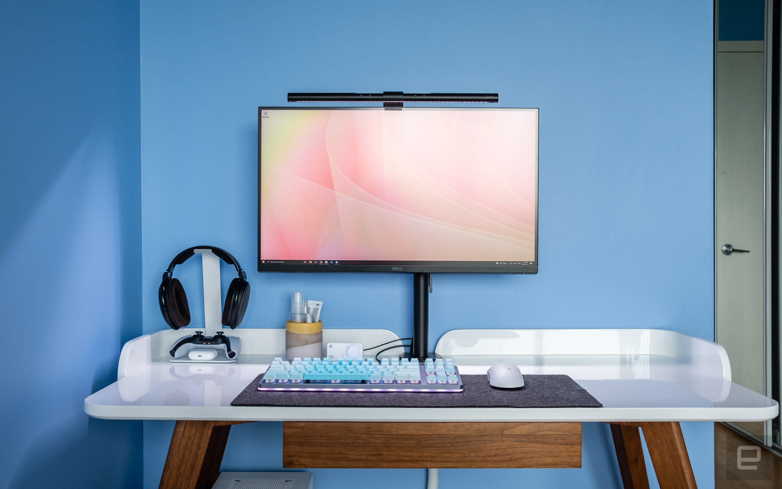 Photo of desk with a BenQ Screenbar mounted to a 27-inch monitor. 