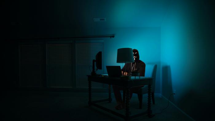 A hacker in a dark room being hacky.