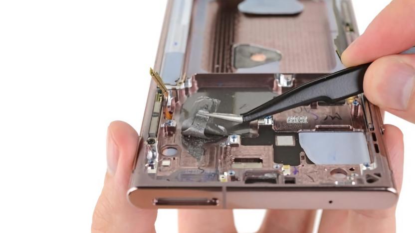 iFixit photo of a person repairing a Galaxy Note 20 smartphone.