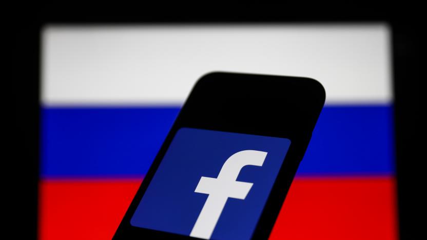 Facebook logo displayed on a phone screen and Russian flag displayed on a screen in the background are seen in this illustration photo taken in Krakow, Poland on March 1, 2022. (Photo Illustration by Jakub Porzycki/NurPhoto via Getty Images)