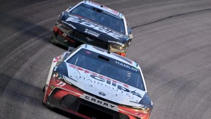 Getty Images - KANSAS CITY, KANSAS - MAY 05: Denny Hamlin, driver of the #11 Sport Clips Haircuts Toyota, and Chris Buescher, driver of the #17 Castrol Edge Ford, race during the NASCAR Cup Series AdventHealth 400 at Kansas Speedway on May 05, 2024 in Kansas City, Kansas. (Photo by Logan Riely/Getty Images)