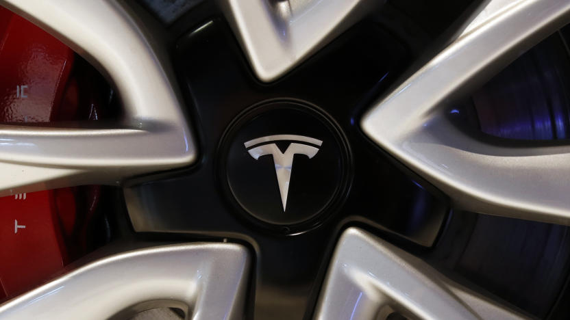 The logo of Tesla model 3 is pictured at the Auto show in Paris, France, Wednesday, Oct. 3, 2018, 2018. All-electric vehicles with zero local emissions are among the stars of the Paris auto show, rubbing shoulders with the fossil-fuel burning SUVs that many car buyers love. (AP Photo/Christophe Ena)