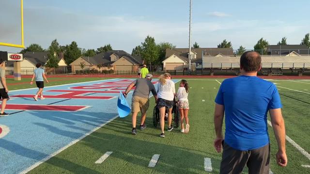 Supporters follow Southside coach Aaron Kareus to the starting line