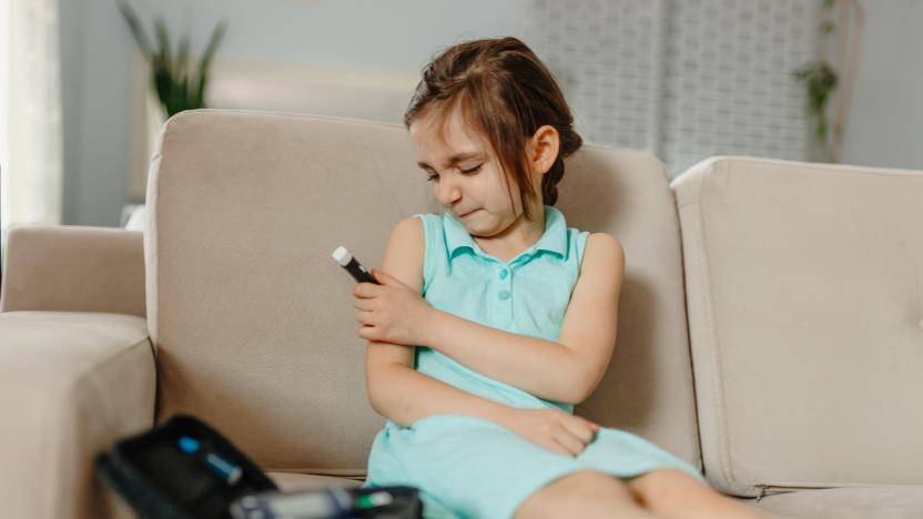 Little girl  is checking his blood sugar level