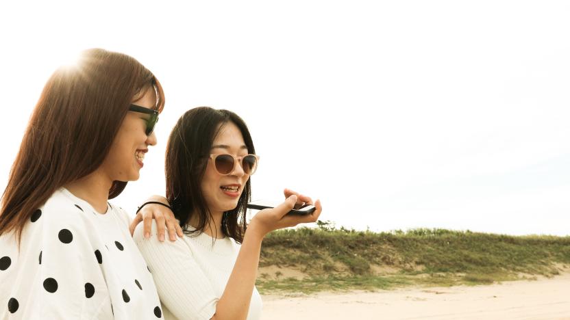 Two young asian woman is using voice recognition