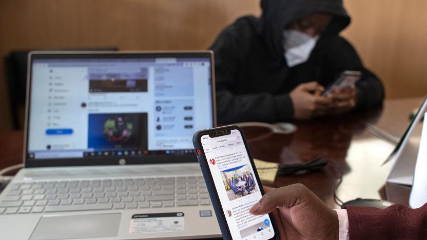 Ian James Mwai (R), 23, browses social media platforms on his mobile phone with a member of his outfit of social media influencers at an office in Thika town, central Kenya on April 26, 2022. - Ian James Mwai is in the vanguard of the growing ranks of influencers feverishly punching keyboards and hoping to tilt the outcome of the country's high-stakes elections, which are barely 100 days away.
The rising dominance of apps like Twitter and Facebook has opened up a new front in Kenyan politics, with candidates desperate to draw the attention of the country's 12 million social media users. (Photo by Tony KARUMBA / AFP) (Photo by TONY KARUMBA/AFP via Getty Images)