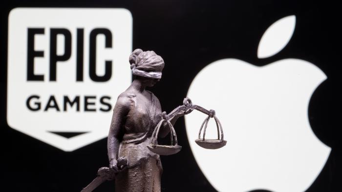 3D printed Lady Justice figure is seen in front of displayed Apple and Epic Games logos in this illustration photo taken February 17, 2021. REUTERS/Dado Ruvic/Illustration