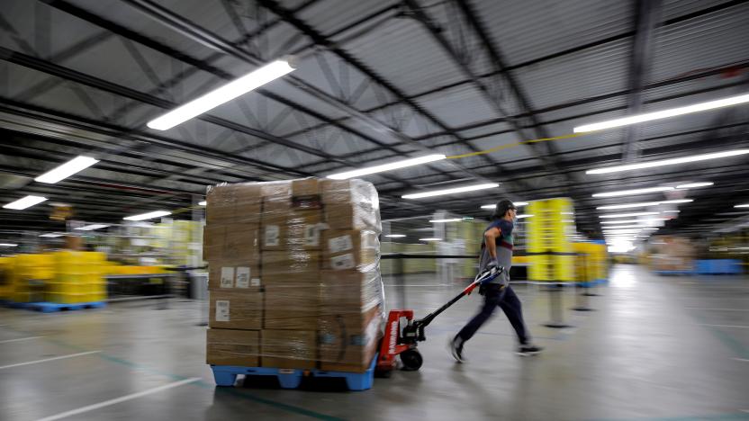 An employee pulls a cart full of items at Amazon's JFK8 distribution center in Staten Island, New York, U.S. November 25, 2020.  REUTERS/Brendan McDermid.     TPX IMAGES OF THE DAY