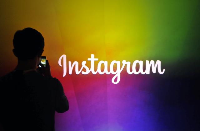 An Instagram employee takes a video using Instagram's new video function at Facebook's corporate headquarters during a media event in Menlo Park, California on June 20, 2013. AFP Photo /Josh EDELSON        (Photo credit should read Josh Edelson/AFP via Getty Images)