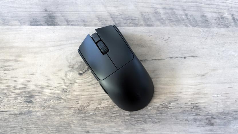 A black Razer Viper V3 Pro gaming mouse rests slightly angled on top of a light brown wooden table.