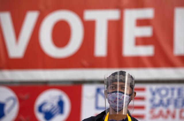 Election worker Tommy Rose wears protective gear as he collects mail-in ballots at the Registrar of Voters on the day of the U.S. Presidential election in San Diego, California, U.S., November 3, 2020.   REUTERS/Mike Blake