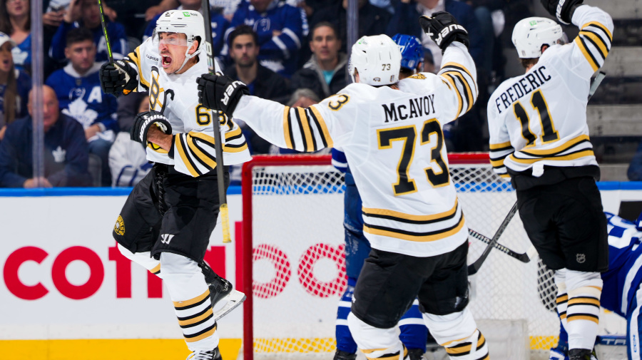 Getty Images - TORONTO, ON - APRIL 24: Brad Marchand #63 of the Boston Bruins celebrators his goal against the Toronto Maple Leafs with teammates Charlie McAvoy #73 and Trent Frederic #11 during the third period in Game Three of the First Round of the 2024 Stanley Cup Playoffs at Scotiabank Arena on April 24, 2024 in Toronto, Ontario, Canada. (Photo by Mark Blinch/NHLI via Getty Images)