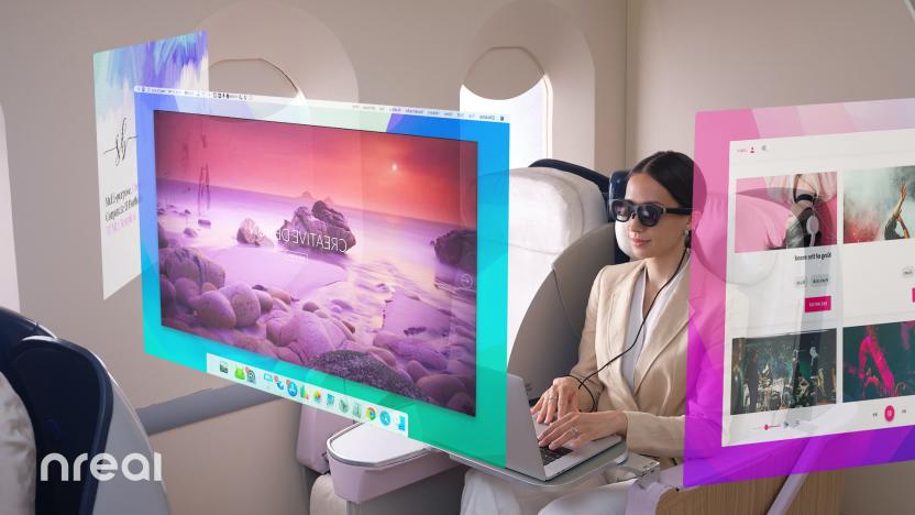 A woman wears Nreal Air augmented reality glasses while on an airplane. Three virtual desktop displays appear to be suspended in midair.