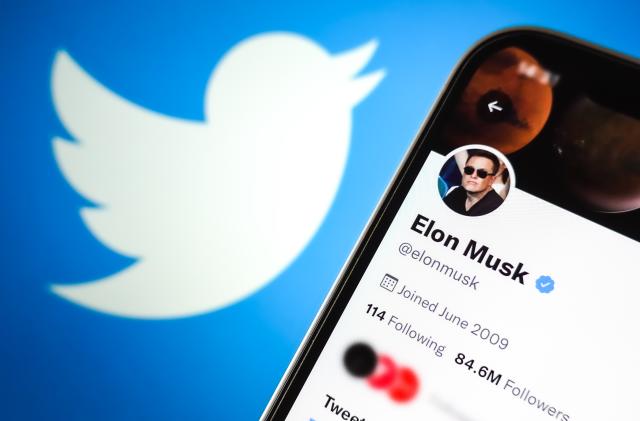 CHINA - 2022/04/26: In this photo illustration, Elon Musk's Twitter account is displayed on the screen of a mobile phone with the Twitter logo in the background. (Photo Illustration by Sheldon Cooper/SOPA Images/LightRocket via Getty Images)