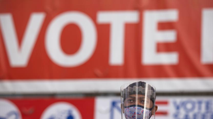 Election worker Tommy Rose wears protective gear as he collects mail-in ballots at the Registrar of Voters on the day of the U.S. Presidential election in San Diego, California, U.S., November 3, 2020.   REUTERS/Mike Blake