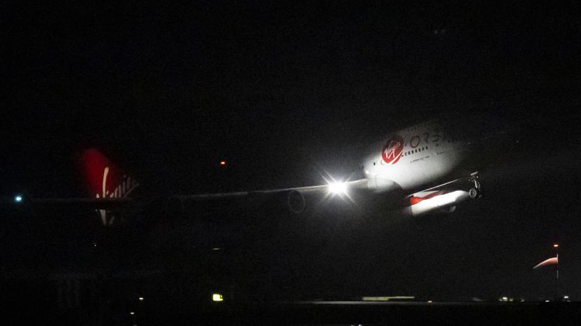 NEWQUAY, ENGLAND - JANUARY 09: Cosmic Girl, a Boeing 747-400 aircraft carrying the LauncherOne rocket under its left wing, takes off from Cornwall Airport Newquay on January 9, 2023 in Newquay, United Kingdom. Virgin Orbit launches its LauncherOne rocket from the spaceport in Cornwall, marking the first ever orbital launch from the UK. The mission has been named Start Me Up after the Rolling Stones hit. (Photo by Matthew Horwood/Getty Images)