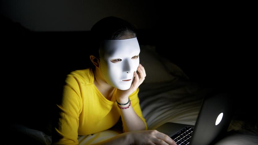 Anonymous teenager in mask on internet at night