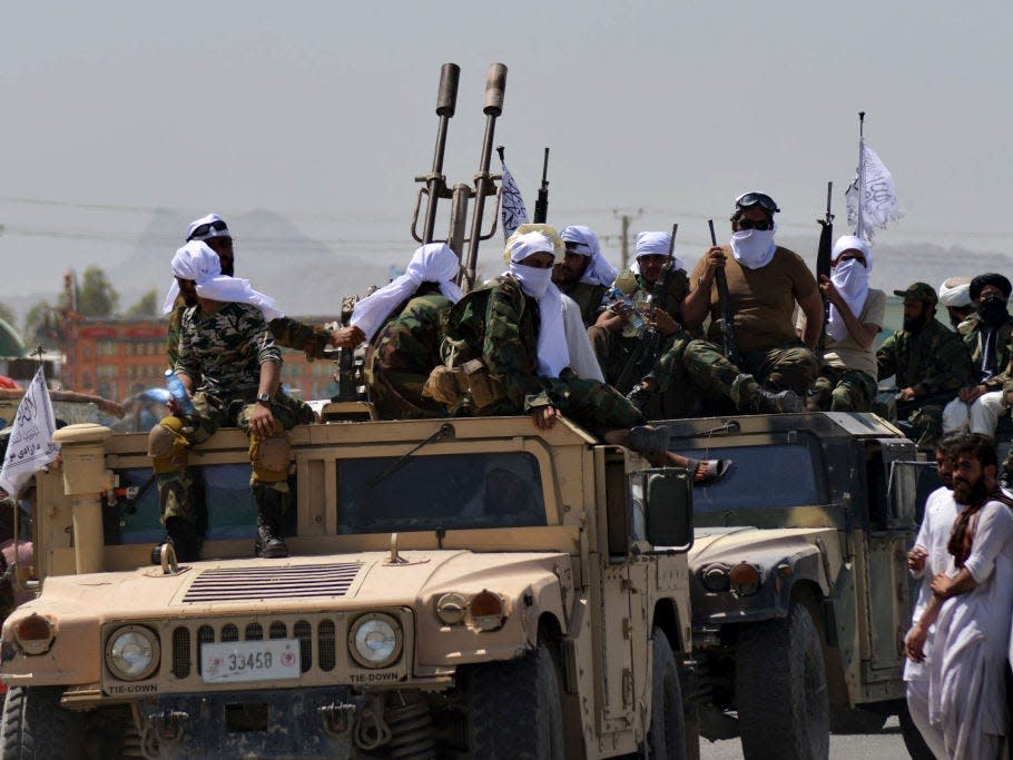 PHOTOS: The Taliban flew a Black Hawk helicopter over a parade of military equip..