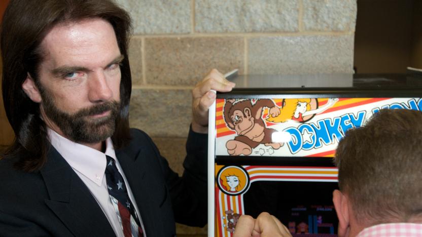 OTTUMWA, IA - AUGUST 13: Billy Mitchell, the Video Game Player of the Century, poses while Steve Sanders, 'The Orignal King of Kong,' plays Donkey Kong at the launch party for the International Video Game Hall of Fame and Museum on August 13, 2009 in Ottumwa, Iowa. Ottumwa was officially proclaimed the Video Game Capital of the World at the launch party and plans are underway to build a full museum in the small Iowa city. The rivelry of Sanders and Mitchell is documented in the movie 'The King of Kong' where they played each other for the best score ever. (Photo by David Greedy/Getty Images)