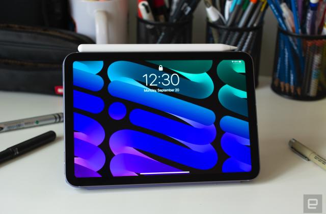 A photo of the 2021 iPad mini on a desk with pens and pencils in the background. 