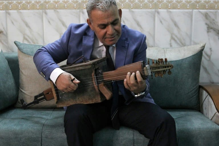 Majed Abdennour transformed a Kalashnikov into a musical instrument (AFP Photo/AHMAD AL-RUBAYE)