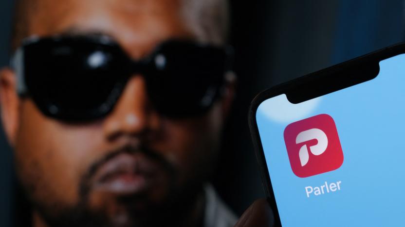 This illustration photo shows the Parler social network app logo on a cell phone screen with a picture of US rapper Kanye West in the background in Los Angeles, October 17, 2022. - Social network Parler announced on October 17 a deal for Kanye West to buy the platform popular with US conservatives, just over a week after the rapper's Twitter and Instagram accounts were restricted over anti-Semitic posts. West -- now known as Ye -- has recently alienated fans and business partners with anti-Semitic comments, interest in racist conspiracy theories and wearing a provocative "White Lives Matter" T-shirt at Paris fashion week. (Photo by Chris DELMAS / AFP) (Photo by CHRIS DELMAS/AFP via Getty Images)