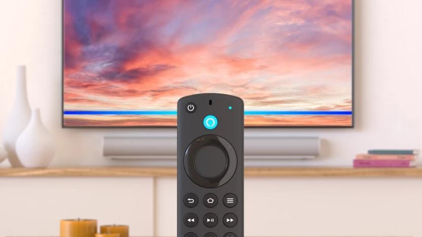 The Alexa Voice Remote included with Amazon's Fire TV 4K Max media streamer is shown in a living room in front of a TV and soundbar.