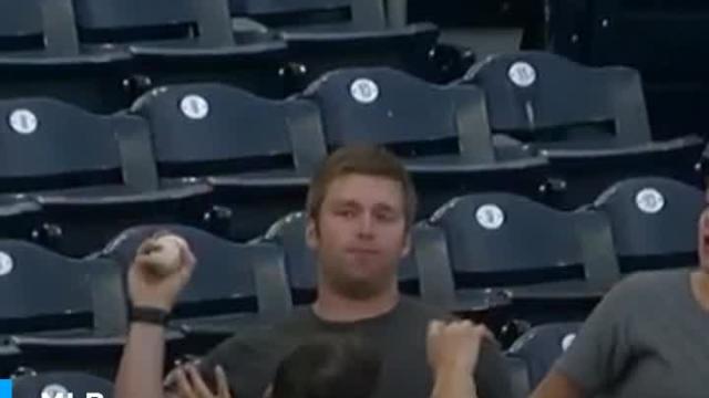Padres fan catches foul ball in the middle of chewing his food