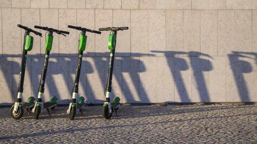 LISBON, PORTUGAL - JANUARY 13: A number of Lime-S e-scooters are parked in a neat row outside MAAT museum by the Tagus River on January 13, 2020 in Lisbon, Portugal. Since their introduction in Lisbon, e-scooters have become very popular with tourists and locals, but have also generated accidents and adverse reactions among the residents. Police are taking action against drivers who do not comply with safety regulations such as driving in pairs or not wearing helmets for accidents related to the use of these vehicles are on the rise. (Photo by Horacio Villalobos#Corbis/Corbis via Getty Images)