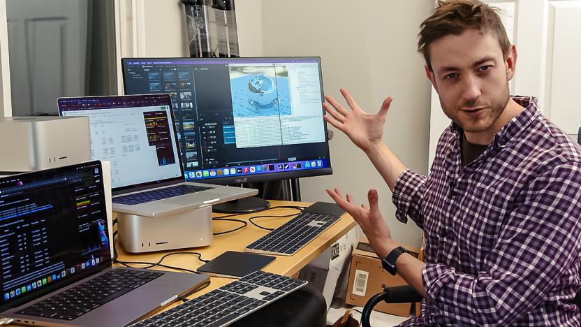 Chris Schodt, the Upscaled host, gestures towards his desk full of Apple computers and keyboards.