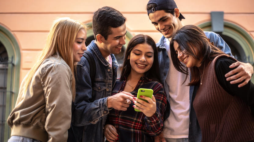 Teenager friends using the mobile phone outdoors