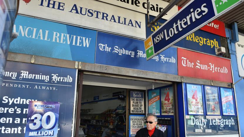 A man leaves a newsagency shop in Sydney on September 14, 2017. 
Controversial changes to Australia's media laws neared agreement on September 14, 2017 in a deal likely to result in significant concentration of ownership, but also a probe into the impact of platforms like Google and Facebook on the industry. / AFP PHOTO / PETER PARKS        (Photo credit should read PETER PARKS/AFP via Getty Images)