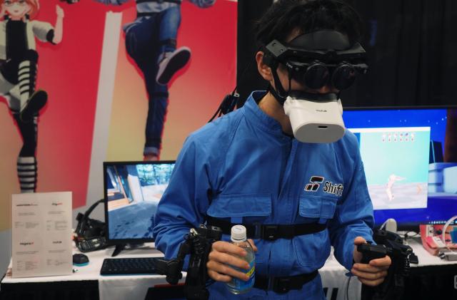 Image of a person demonstrating all of Shiftall's VR technology.